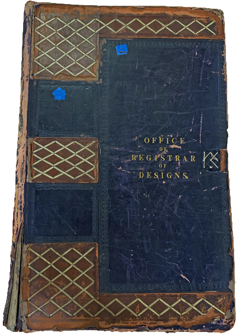 The cover of a blue book, titled Office of Registrar of Designs.