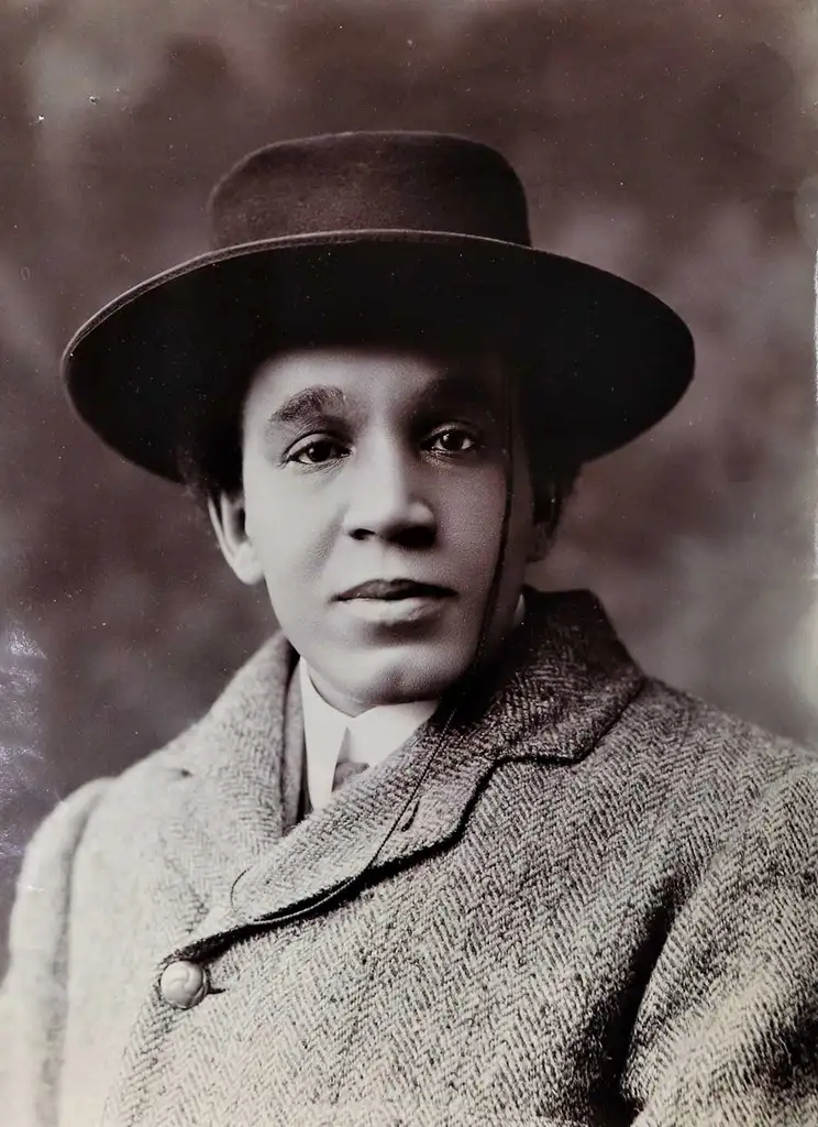 A head and shoulders shot of Coleridge-Taylor. He wears a smart overcoat and a hat.