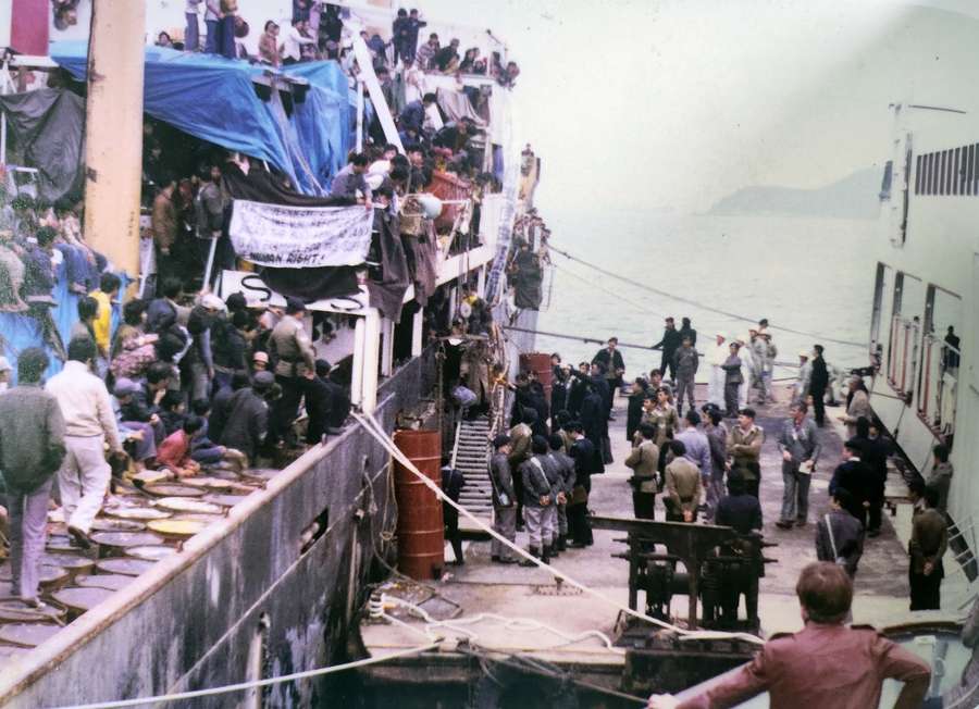 A photograph showing the refugees getting ready to leave the Huey Fong onto dry land.