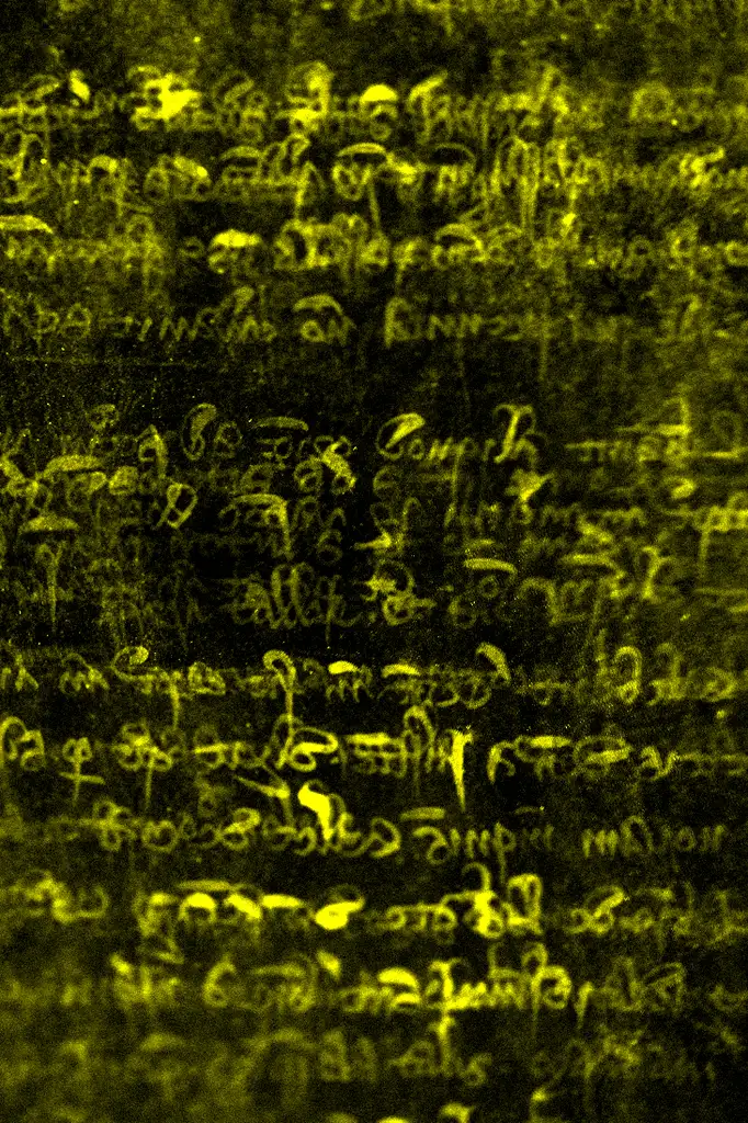 A scanned roll exposing writing, yellow after being scanned. The background is black.