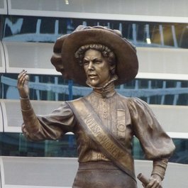 A bronze statue of Alice Hawkins holding up her fist