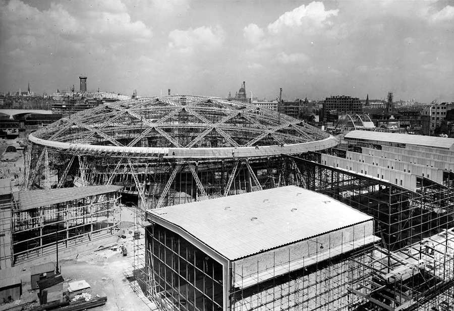 A building under construction with the London skyline in the background