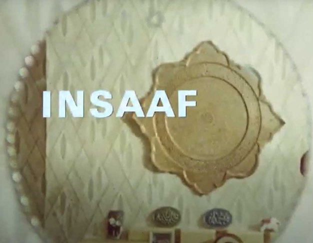 Title card of Insaaf. A mirror on a white wall with the word Insaaf overlaid in white