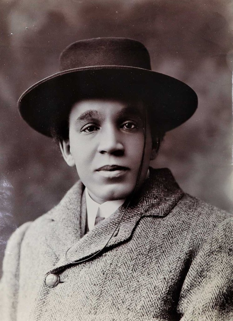 A head and shoulders shot of Coleridge-Taylor. He wears a smart overcoat and a hat.