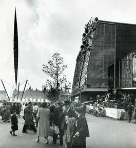 Visitors looking at the Skylon - a thin, upright structure towering into the sky