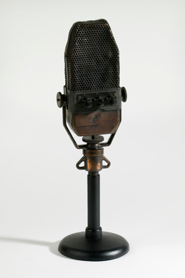 A metal microphone on a short stand.