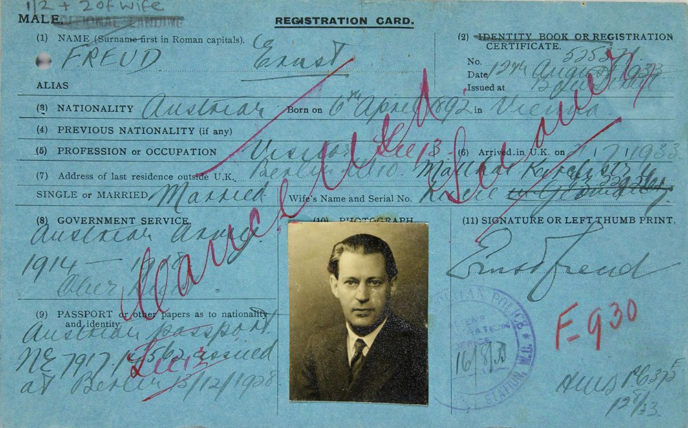 A blue registration card with a small black and white photograph of a middle aged man in a suit