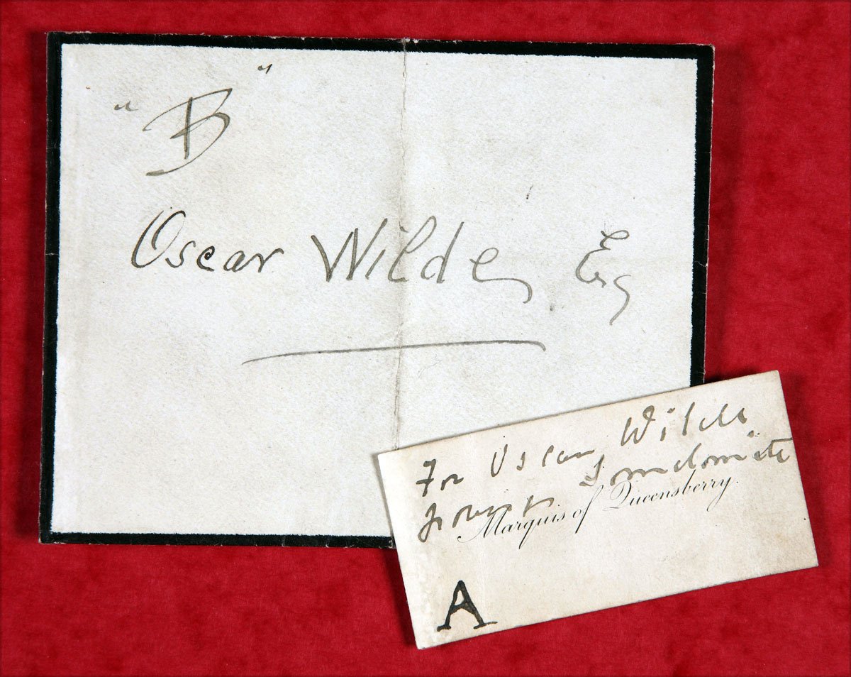 A calling card with the words 'B Oscar Wilde' alongside a smaller piece of paper 'A' with words.
