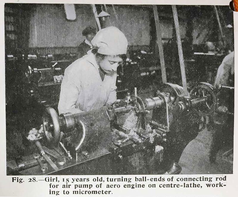 A newspaper photograph of a young woman wearing a white cap and white coat working on a machine