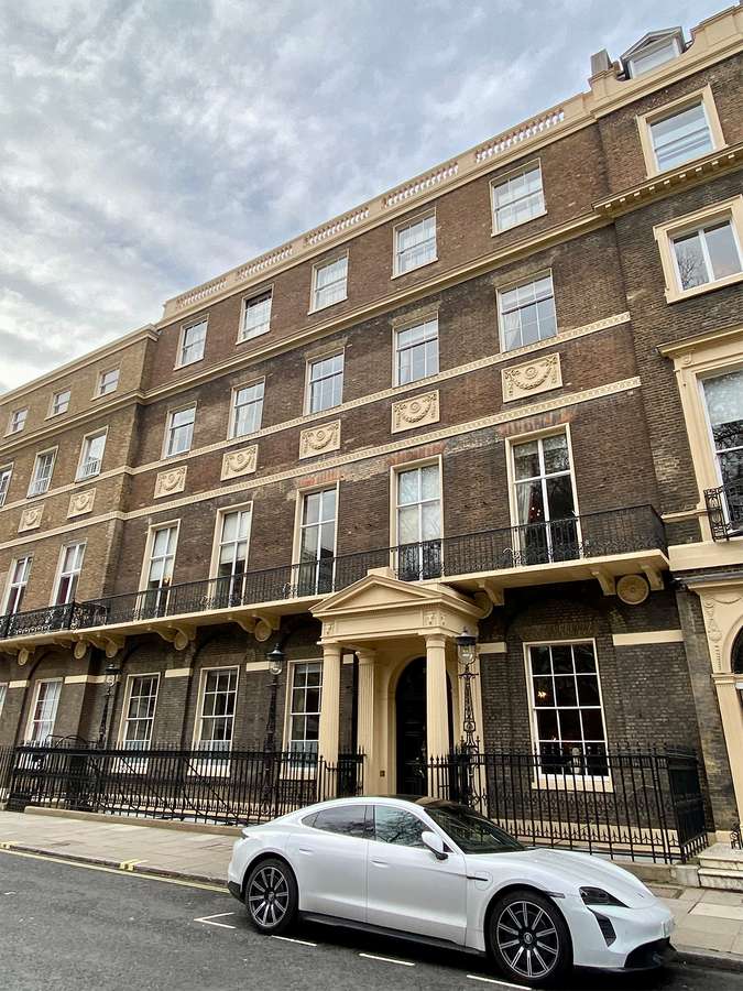 Photo of an elegant terraced building with decorative pillars and facades.