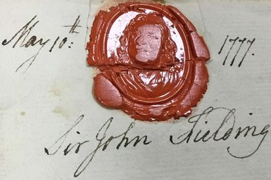 A red wax seal showing the outline of a man's face, with hair dropping past his shoulders..