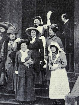 Photograph of a group of smartly women standing on the steps of a building