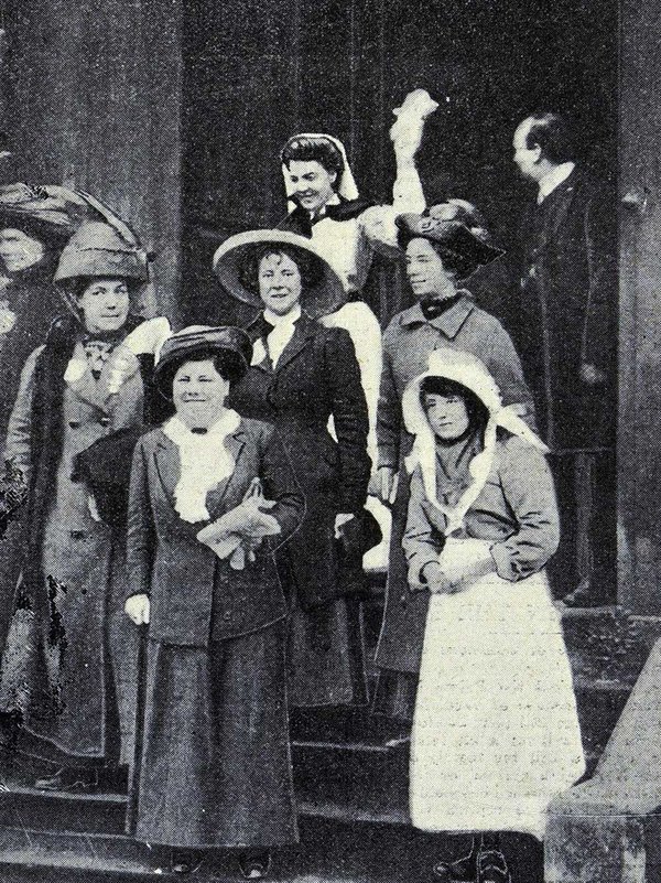 Photograph of a group of women standing on some steps