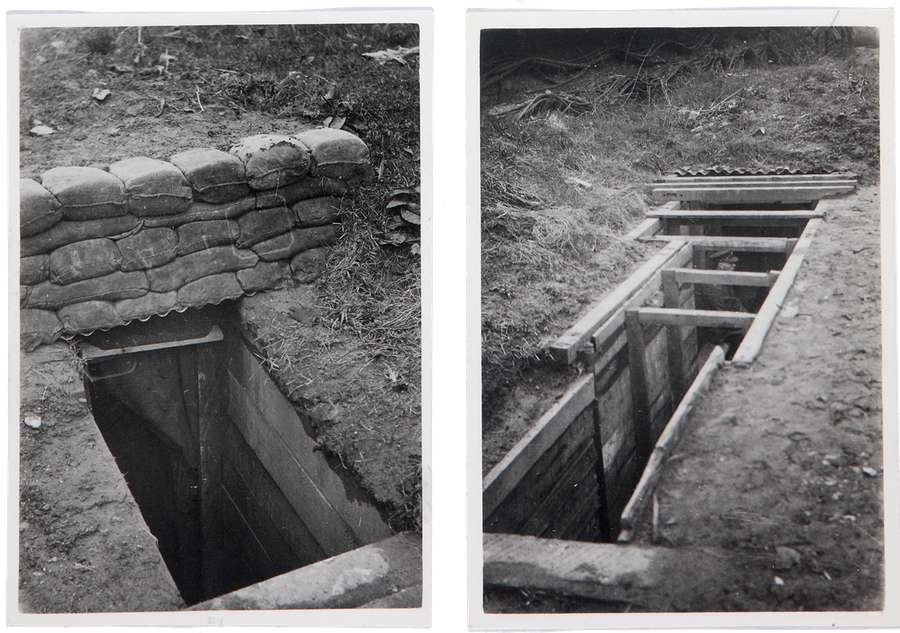 Wooden planks and sandbags above the entrances to two trenches, respectively.