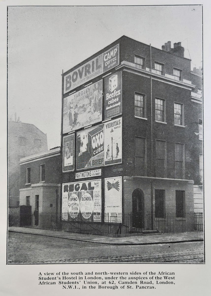 An end of terrace townhouse in London with lots of advertisements on its side, including for Bovril.